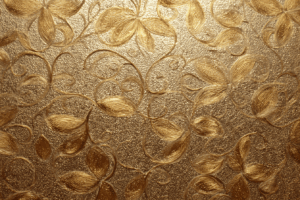 金色の浮き彫り模様で描かれた花と葉のデザインが広がる、豪華で装飾的なテクスチャ背景。